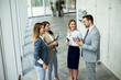 © BGStock72 - Young startup team have a discussion by stairs in the office corridor