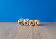 Ethical or moral symbol. Businessman turns wooden cubes and changes the word 'moral' to 'ethical' on a beautiful wooden table, blue background. Business and ethical or moral concept. Copy space.