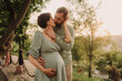 © Forewer - Husband with his pregnant wife walking in park. Happy family concept photo. No focus blurred and noise effect