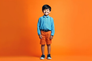 Asian kid on orange studio background, cute smiling child portrait, generative AI.