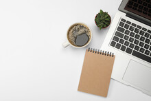Modern Laptop, Notebook, Houseplant And Cup Of Coffee On White Background, Flat Lay. Space For Text