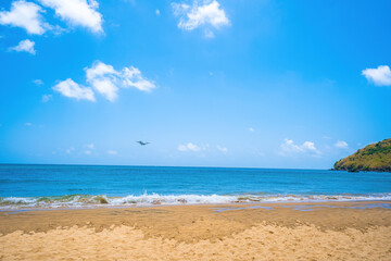 Beautiful Dam Trau beach in Con Dao island. Bottom view Airplane is landing. Wild beach Con Dao island from above with blue sea and mountain, so many cloud.