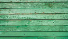 Old Wooden Fence With Green Paint Background Texture.