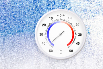 Celsius scale thermometer on a frozen window shows minus 44 degrees