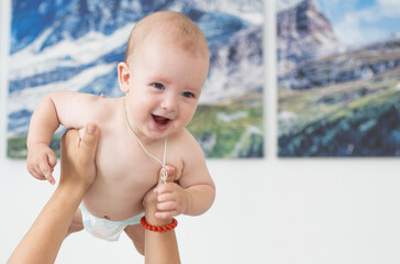 Wall Mural - picture of happy mother with baby in hands