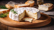 Cut brie cheese a soft French cheese on a wooden board