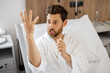 © rh2010 - Funny portrait of a male patient looks on his healed hand, while lying in medical ward after a surgery