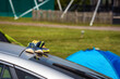 Children shoes on car roof next to tents at camping site in england uk