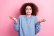 Photo of funky unsure lady wear blue sweatshirt shrugging shoulders isolated pink color background