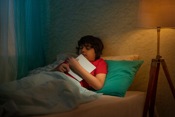 Portrait of little boy sleeping on bed