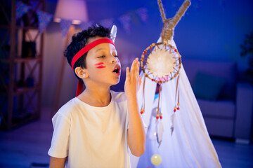 Sticker - Photo of brave little kid playing game native americans battle crying protect his tent in evening nursery playroom