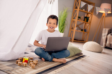 Sticker - Photo of sweet cute schoolkid on covid quarantine playing homemade camp use netbook for zoom meeting lesson