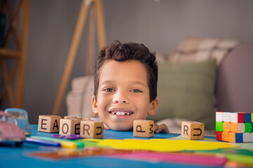 Poster - Photo of pretty sweet small boy smiling making works letters cubes indoors room home house