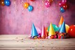 Festive birthday celebration background featuring colorful cone hats confetti, and vibrant balloons.