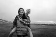© Jacob Lund - Best friends enjoying a piggyback ride with smiles