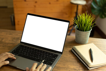 Wall Mural - mock up empty screen computer on wood desk in home.Notebook Laptop with blank screen