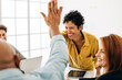 © (JLco) Julia Amaral - Colleagues doing a high five in an office