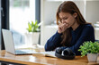 © Wuttichaik - Stress, student with laptop at home frustrated agry unhappy young woman looking at laptop screen book, Exhausted female student studying online with computer