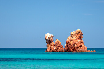 Cea beach with the Red Rocks, the Red Rocks - Faraglioni. White sand and crystal clear water. Tortoli, Ogliastra, Sardinia, Italy