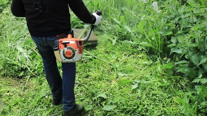Poster - man mowing grass with a trimmer
