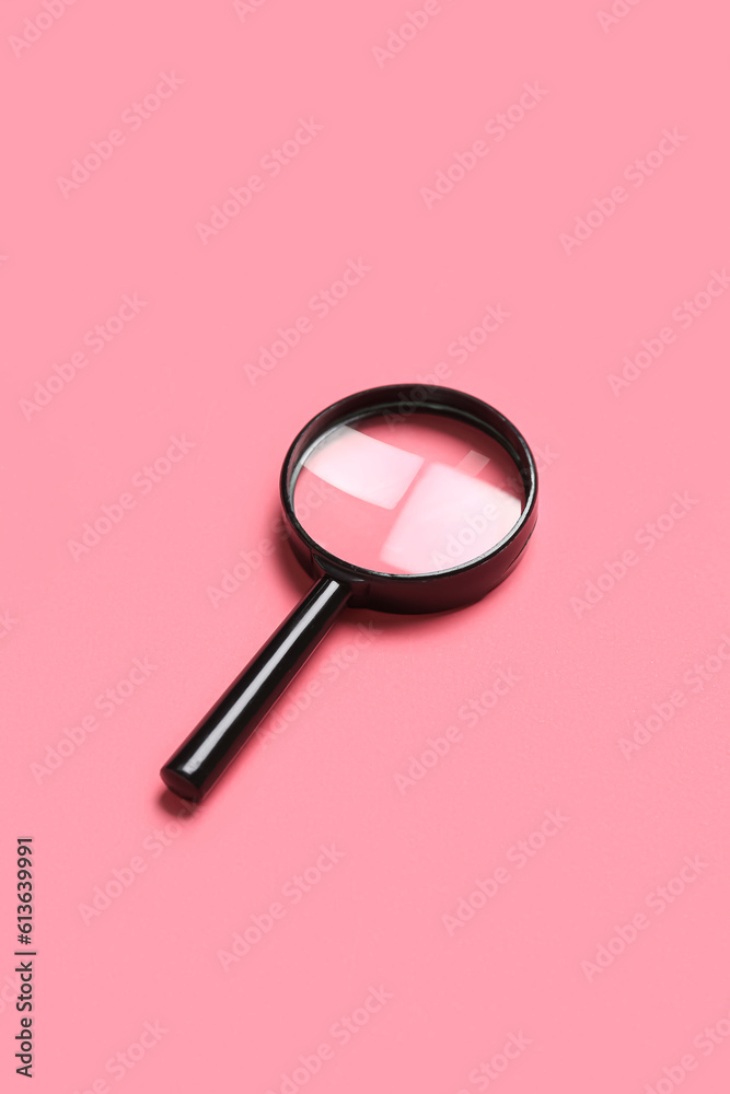 Black mini magnifier on pink background