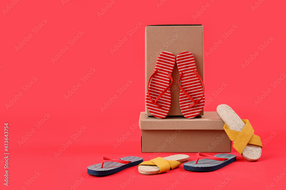 Cardboard boxes with different female slippers on red background