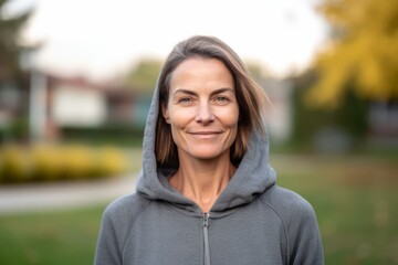 Wall Mural - Portrait of mature woman in sportswear smiling at camera.