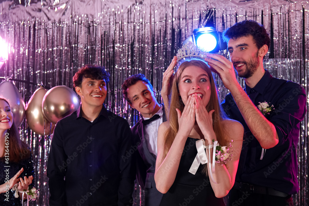 Young people crowning queen on prom night