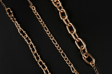 Beautiful chain bracelets on black background