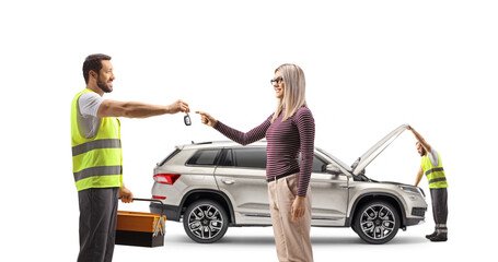 Wall Mural - Road assistance agent giving SUV keys to a woman