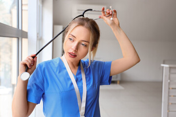 Wall Mural - Female medical intern with stethoscope in clinic