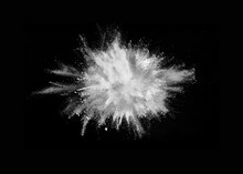 White Powder Explosion Isolated On Black Background	
