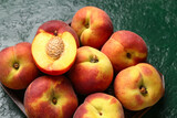 Fototapeta Kuchnia - Tray with sweet peaches on green background