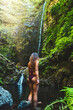 © Michael - Tourist woman in bikini enjoys a refreshing bath in the pool at a picturesque overgrown waterfall in Madeira rainforest. Levada of Caldeirão Verde, Madeira Island, Portugal, Europe.