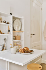 some food on a table in a room with white walls and open doors behind it is a bowl of bread