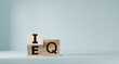 © Smile Studio AP - Flipping of EQ to IQ which print screen on wooden cube block. Smart idea and smart emotion concept.