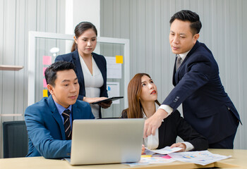 Asian professional successful male female businessmen businesswomen in formal business suit sitting standing talking in video call meeting online in laptop notebook computer