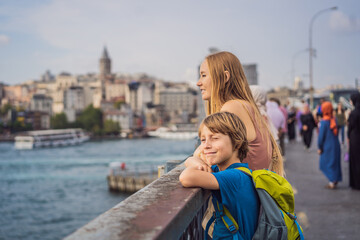 Wall Mural - Portrait of beautiful mother and son tourists with view of Galata tower in Beyoglu, Istanbul, Turkey. Turkiye. Traveling with kids concept