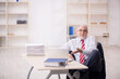 © Elnur - Old male employee and too much work at workplace