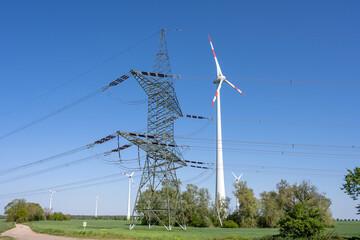 Wall Mural - Electricity pylon and a wind turbine seen in Germany