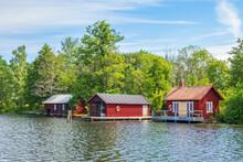 Beach With A Red Cabin And Boathouse On The Göta Canal In Sweden