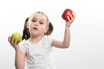 On a white background, the girl holds two green and red apples in her hands