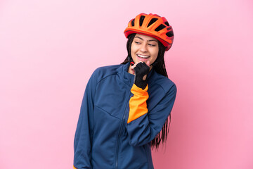 Poster - Teenager cyclist girl isolated on pink background looking to the side and smiling