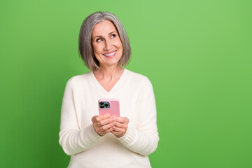 Poster - Photo of pensioner old woman wear white pullover hold gadget order eshopping proposition look mockup isolated on grey color background