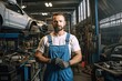 © ttonaorh - Handsome mechanic in uniform in auto repair shop
