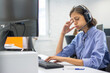 © Bojan - Tired call center operator woman at workplace in office.