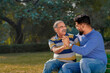 © Niks Ads - Old indian father with his young son spending time at park.