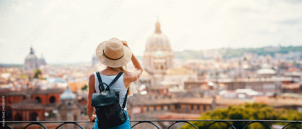 Young attractive smiling girl tourist exploring new city at summer