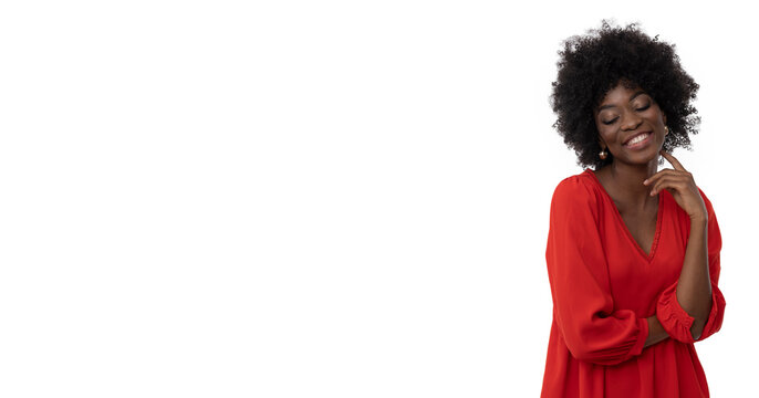 Positive young woman with afro hair style and dark skin in red dress on isolated white background.