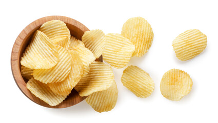 Potato chips spilled from a wooden plate on a white background. Top view